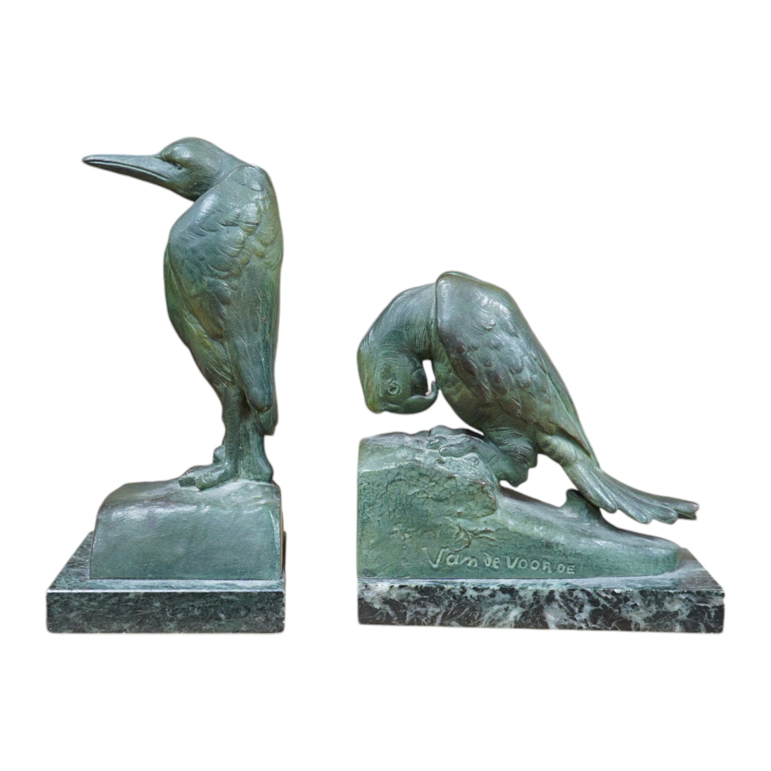 Georges Van de Voorde (Belgian 1878-1970). A pair of Art Deco bronzed spelter bookends modelled as a parrot and stork, on marble plinths, tallest 21.5cm. Condition - fair to good.